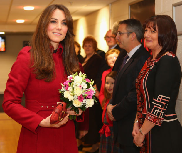 Kate Middleton opted for a formal red winter coat for her rugby date with William
