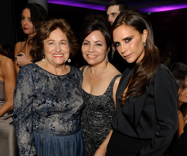Victoria cosies up to Eva's mum and sister at the Global GIft Gala