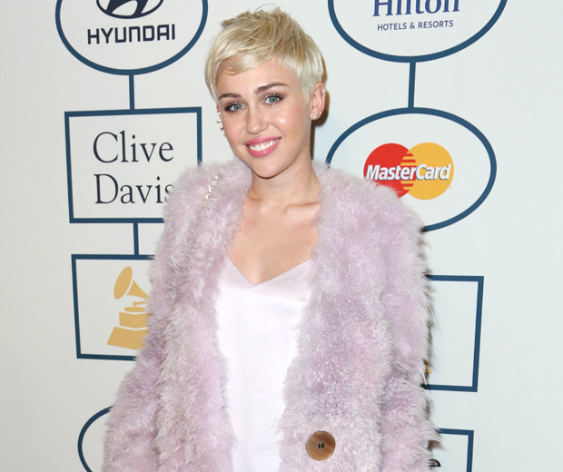 Miley looked pretty in pink Calvin Klein at the Clive Davis pre-Grammys bash