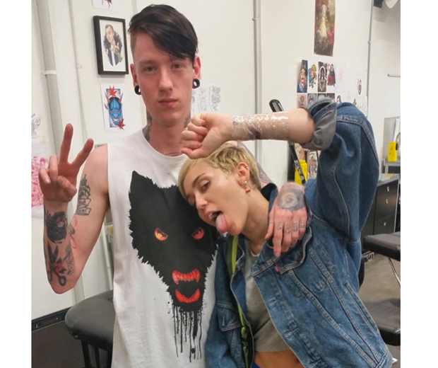 Miley heads straight to the tattoo parlour with her brother after touching down in Melbourne