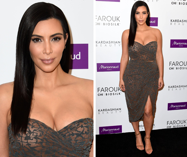 Kim Kardashian works a sleek and straight hair look as she draws a huge crowd at the Kardashian Beauty Hair launch in Paris