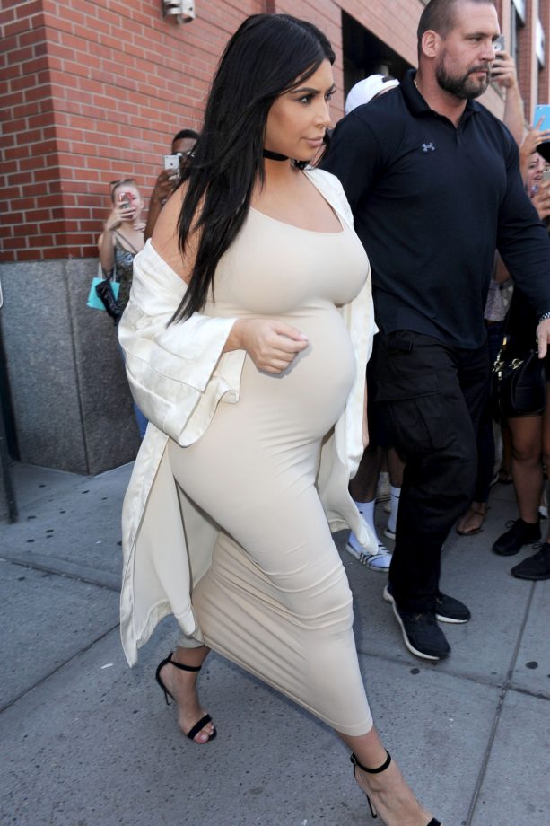 Kim Kardashian Teams A Super Stretch Nude Dress With A White Coat And Strappy Sandals, 2015