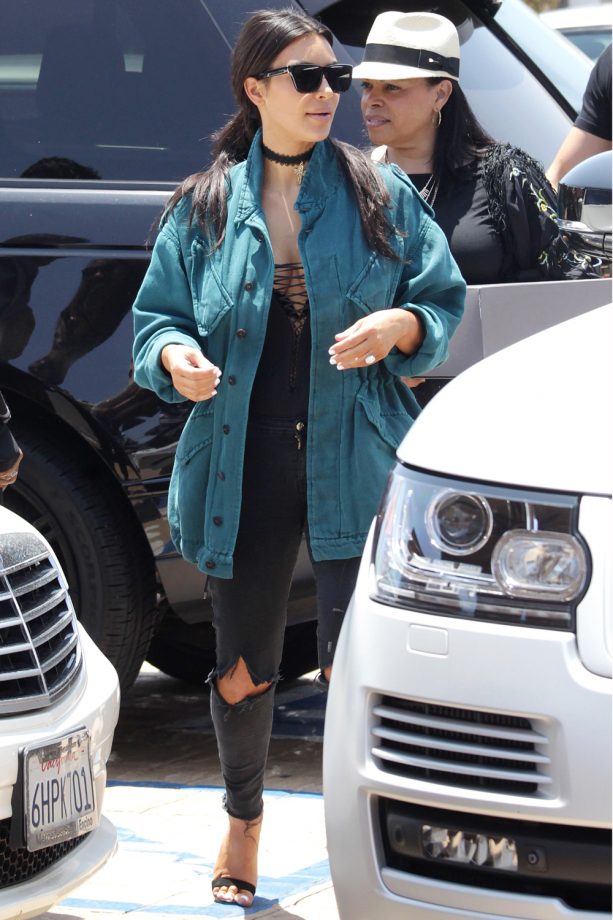 Kim Kardashian Looks Cool In Casual Ripped Jeans And An Oversized Teal Vintage Jacket, 2016