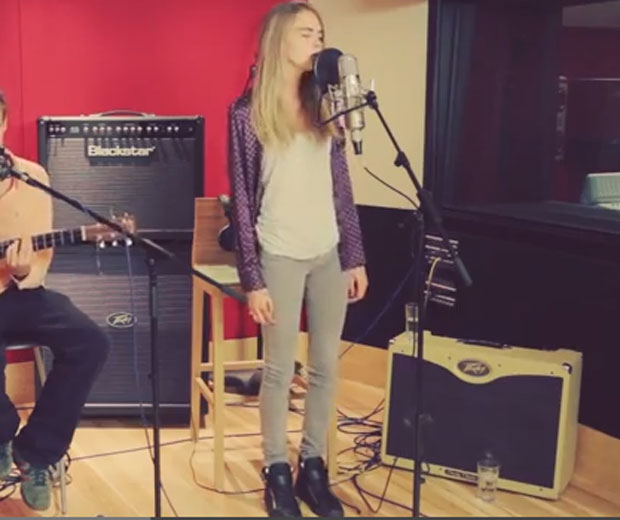 Cara hits the studio to perform an acoustic cover with pal Will Heard