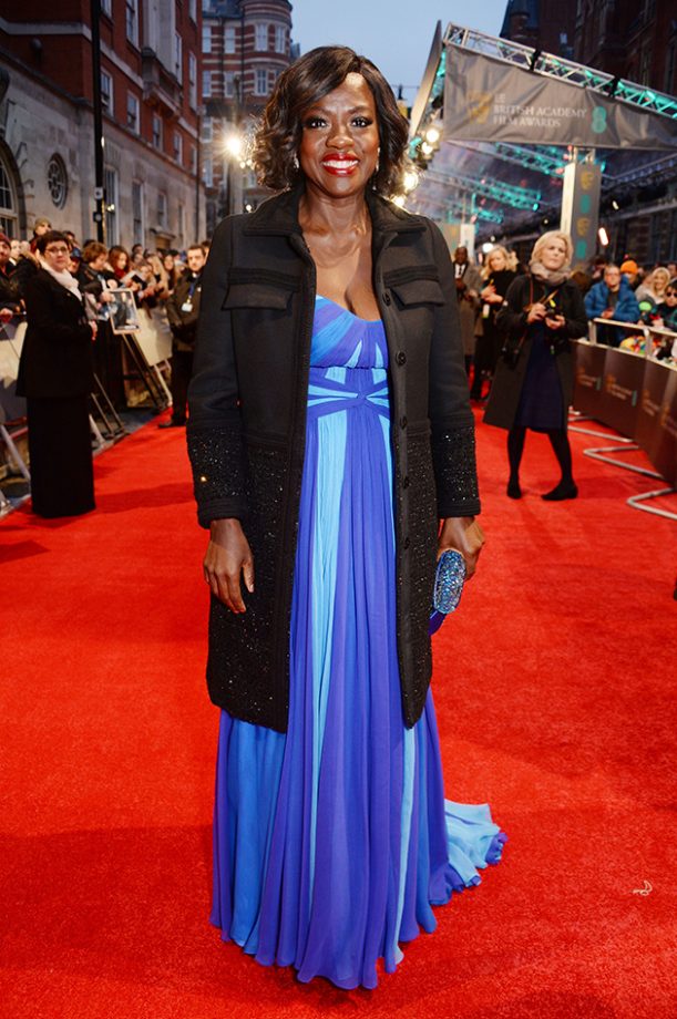Viola Davies protected herself from the chill with a shimmering black coat. We love that multi blue gown, too