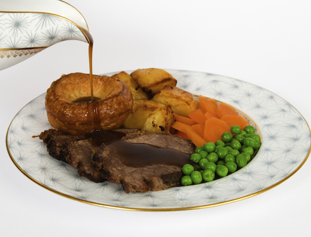 Roast beef with yorkshire puddings, gravy being poured veggie