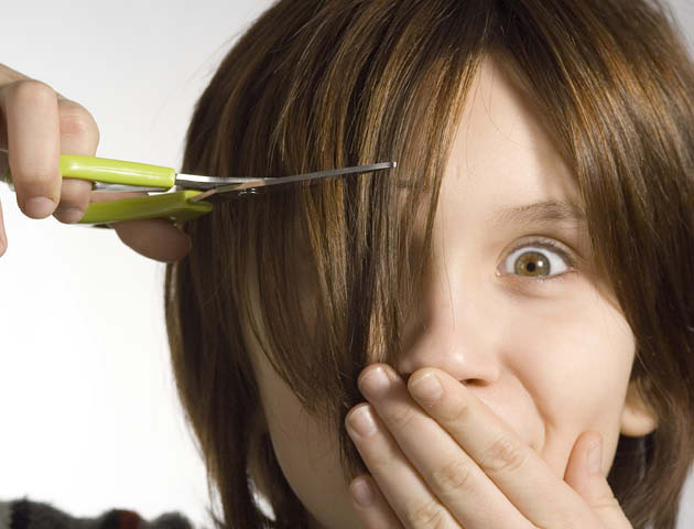 Woman cutting own fringe