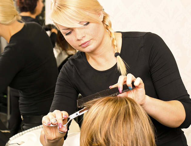 Hairdresser cutting fringe