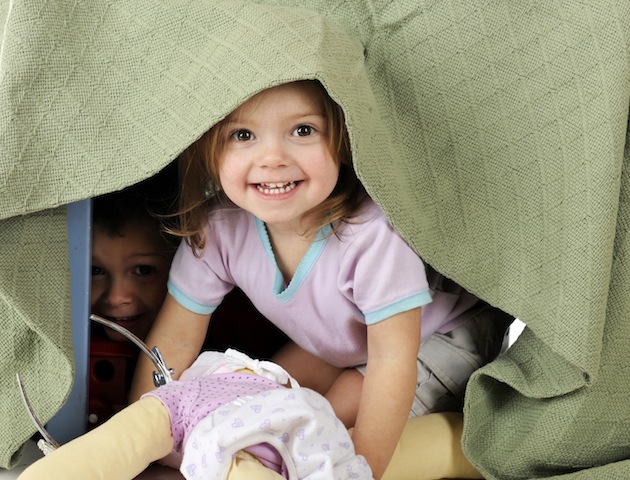 Kids in the 70s: girl playing in den under table