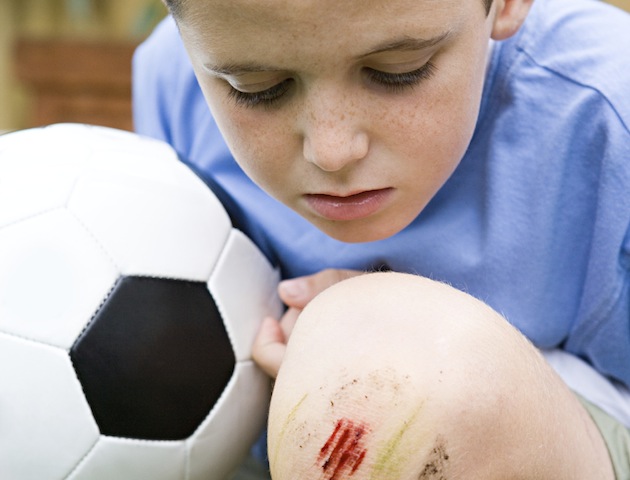 70s kids: boy with grazed knee