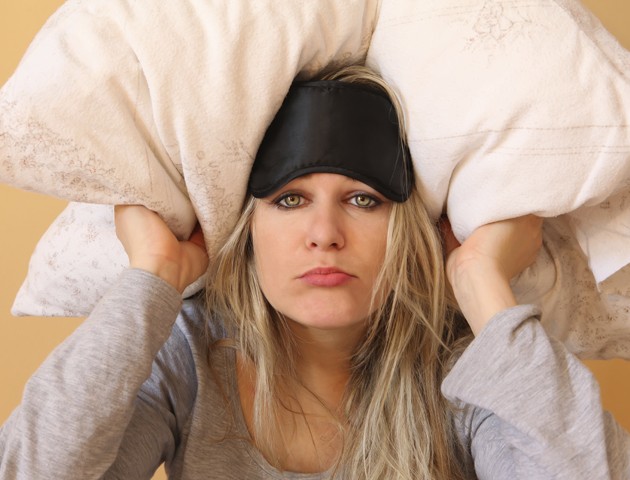 image of woman with cushion over her head
