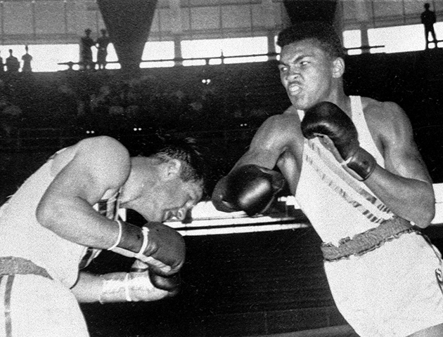 FILE - In this Sept. 3, 1960, file photo, Cassius Clay, right, 18-year-old from Louisville, Ky., throws a right at Tony Madigan of Australia, during the light heavyweight boxing semifinals at the Summer Olympic Games in Rome, Italy. Cassius Clay later changed his name to Muhammad Ali. Ali turns 70 on Jan. 17, 2012. (AP Photo/File)