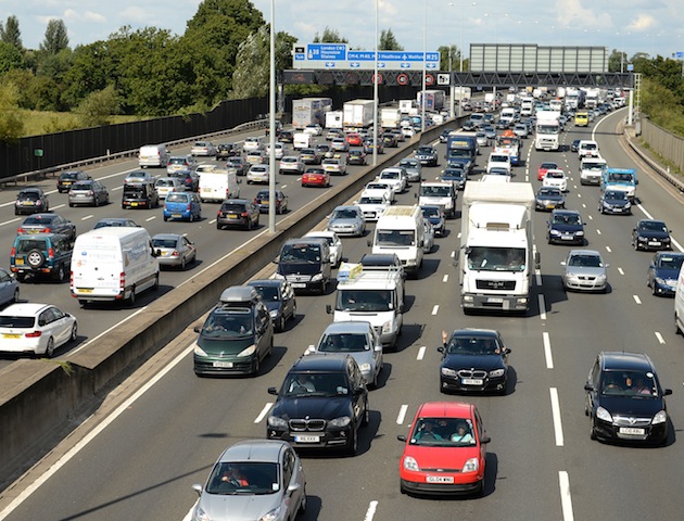 Motorists start to queue in heavy traffic on the M25 between junction 12 and 13 as the August Bank Holiday getaway begins PRESS ASSOCIATION Photo. Picture date: Friday August 22, 2014. See PA story TRAVEL . Photo credit should read: Andrew Matthews/PA Wire