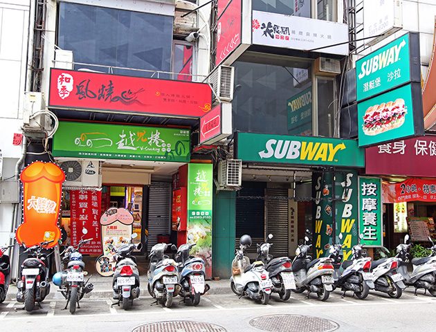 The shop blends in next to a Subway