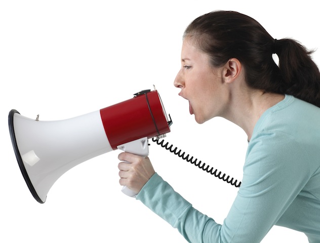 A young woman shouting into a megaphone.