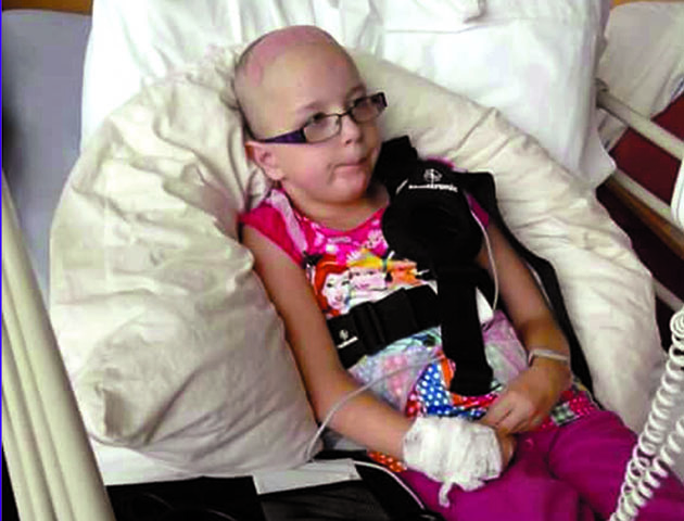 Collect photo of Eleanor recovering in hospital.A mum whose daughter suffers from an extremely rare muscle condition has decided to get a permanent tribute tattoo on her chest - of her girl's BRAIN. See swns story SWBRAIN. Zara Gabriel got inked in honour of her daughter's extreme bravery after she was born with a genetic mutation - showing a scan of her damaged brain. Eleanor, 14, suffers with muscular dystrophy, cardiomyopathy and dystonia – all of which affect her ability to control body movement. This combination of ailments means the teen is one of only five people in the world to suffer with the disability. When she was just eight she underwent a brain operation called 'deep brain stimulation' (DBS) which involved placing a stimulator on her chest and doctors drilling into her brain in an attempt to help her control her muscle movements. Zara, 36, said: “I wanted to raise awareness of dystonia and DBS but couldn’t think of anything appropriate until I saw a brain x-ray Eleanor had done showing her stimulator and electrodes. “I love Gothic things - I am a big horror fan and always wanted to get a skull tattoo but didn’t want something everyone else has. “So I decided to get Eleanor's brain x-ray tattooed onto my chest as a tribute to her bravery and to raise awareness of dystonia and DBS.” The family are now trying to raise money to build a hydrotherapy spa pool in the garden, as this is the only way for Eleanor to relieve the pain and exercise.