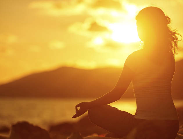 Person meditating in sun