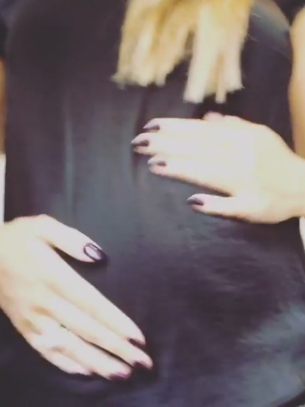 Emily shows off her growing baby bump