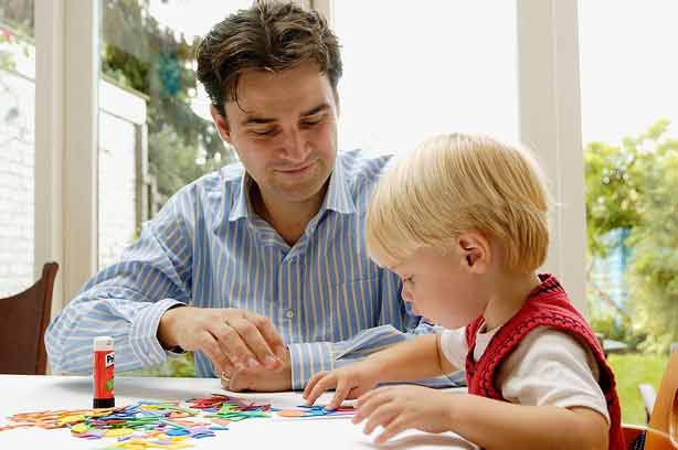 A dad helping his child with drawing and craft