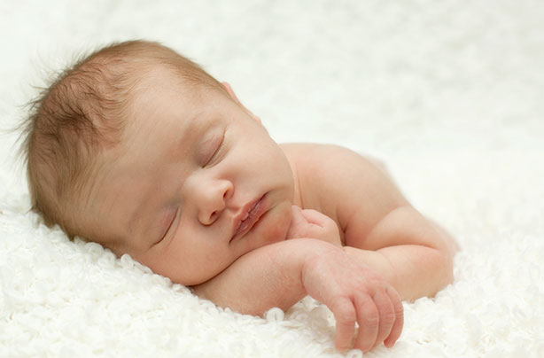 A new born baby photographed in an after birth photoshoot