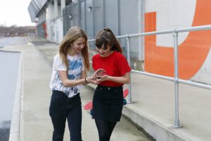two teenagers walking down the road