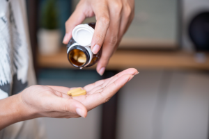 woman taking vitamin d tablet