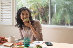 woman eating breakfast high in vitamin D