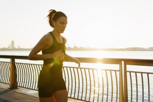 woman jogging in sunshine, known to create vitamin d