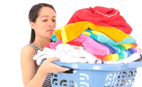 Woman carrying a pile of washing
