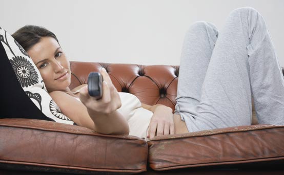 Woman changing the TV channel