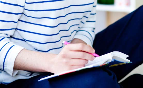 Woman writing a shopping list