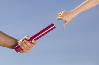 Father handing son baton