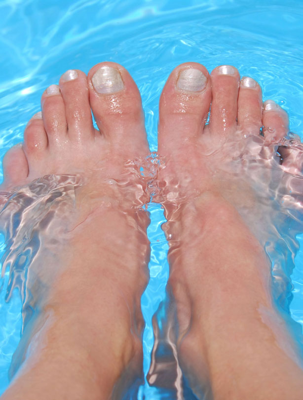 woman with feet in pool