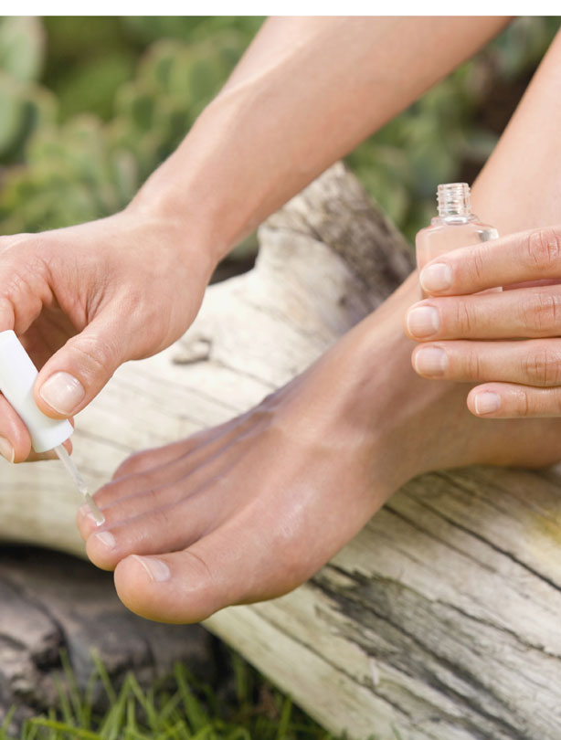 Woman painting toe nails