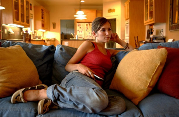 Woman watching TV alone