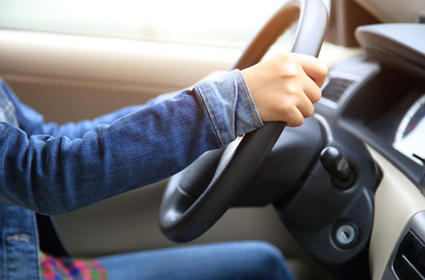 Woman driving, steering wheel