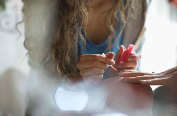 Girl giving her mum a manicure