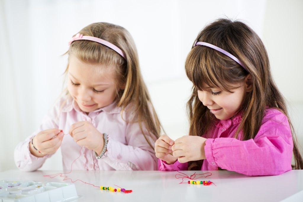 girls making bracelets