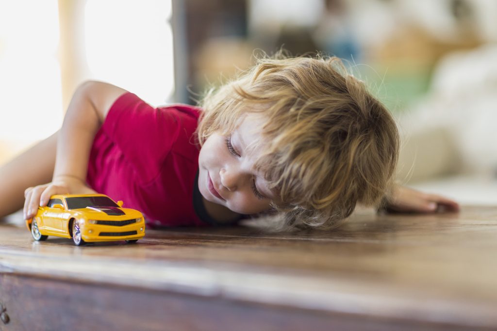 child with toy car