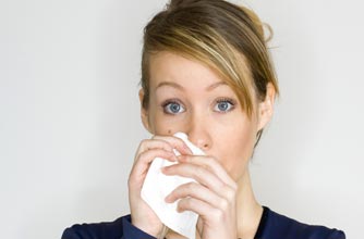 A woman using a tissue