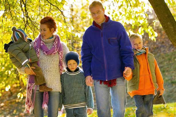 A family of five go on a walk in autumn