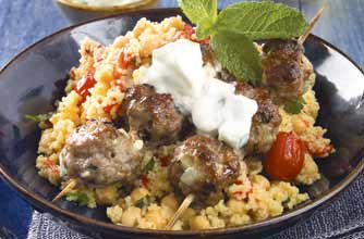 Grilled lamb mince balls in bamboo skewers. This is served with chickpeas, couscous and peppers. For added zing, werve with tzatziki