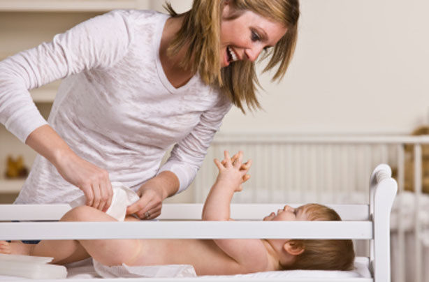 Mother changing her baby