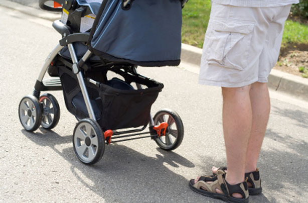 Dad and new baby in a pram