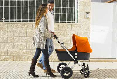 Parents pushing baby in a pram