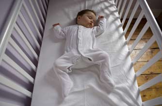 Baby asleep in cot