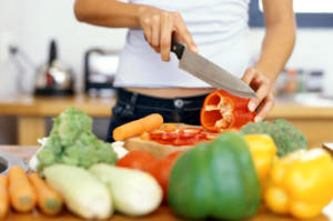 A woman preparing and chopping vegetables