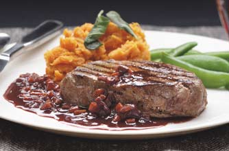 A rich red wine sauce is served with pan fried fillet steak. This steak is moist, tender and very tasty.