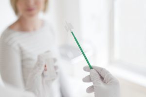 Doctor holding cervical smear equipment.