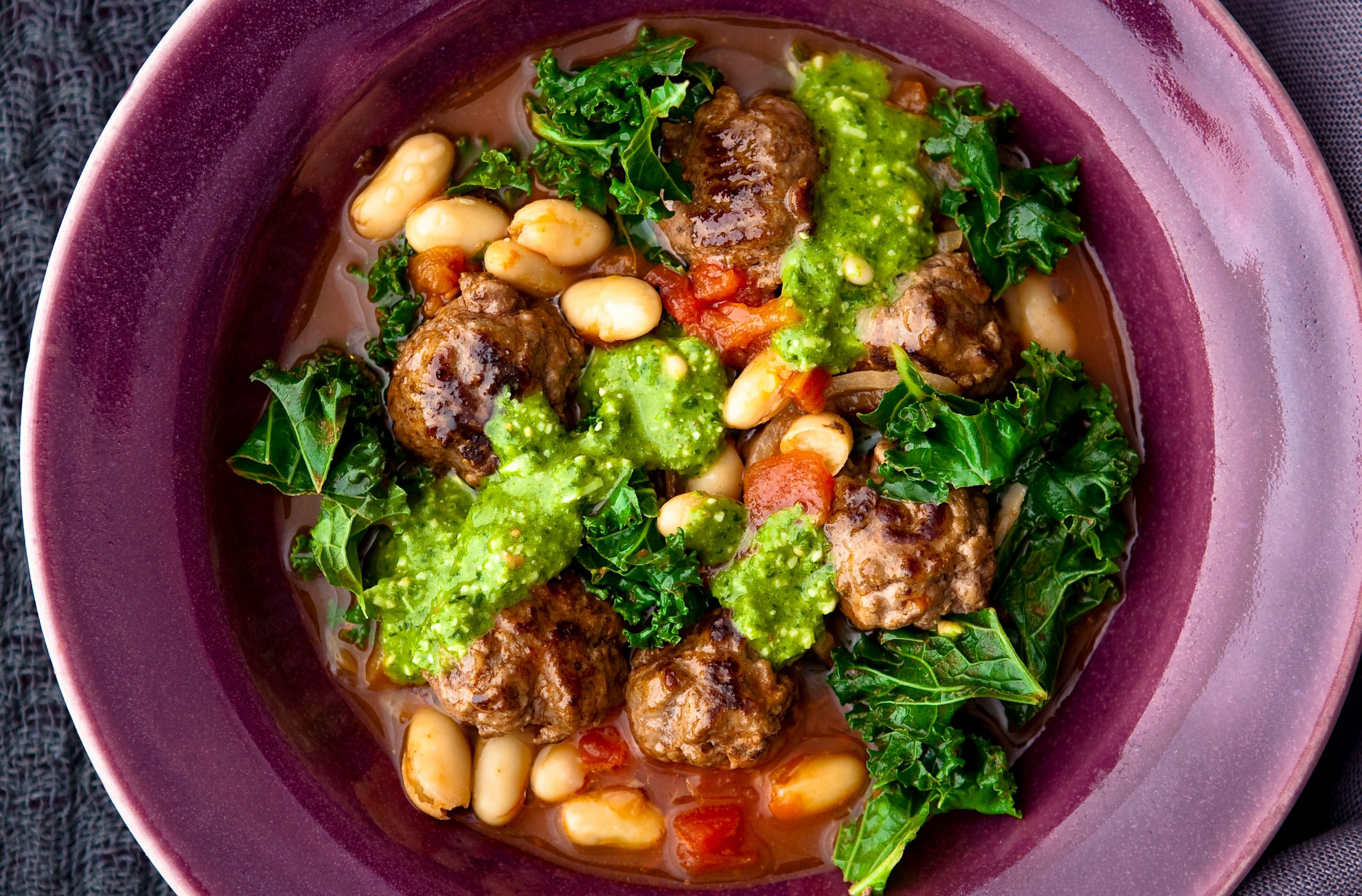 Meatballs and beans in tomato broth